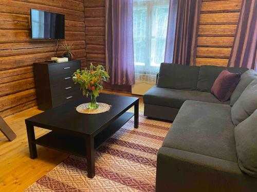 a living room with a couch and a coffee table at Very lovely Old Down place close to Castle in Rakvere