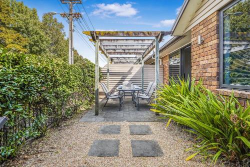 a patio with a table and chairs next to a house at Park view, Proximity, Value in Hamilton