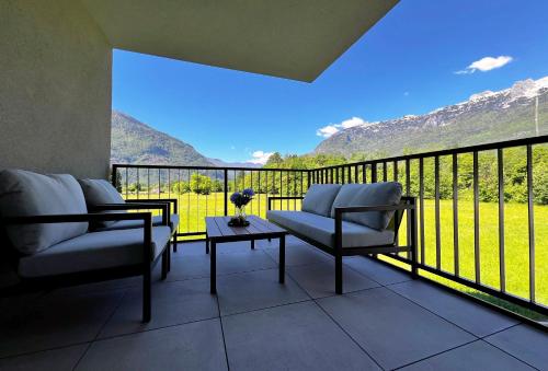 a balcony with two chairs and a table with a view at Alpine Haven in Bovec