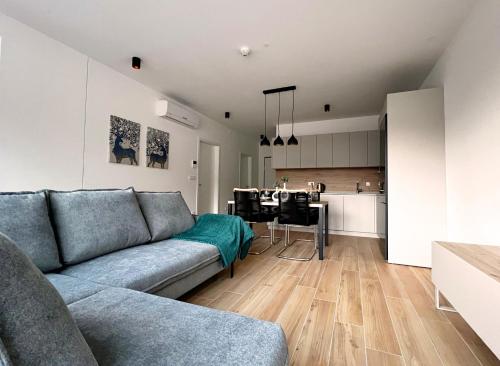 a living room with a couch and a kitchen at Alpine Haven in Bovec
