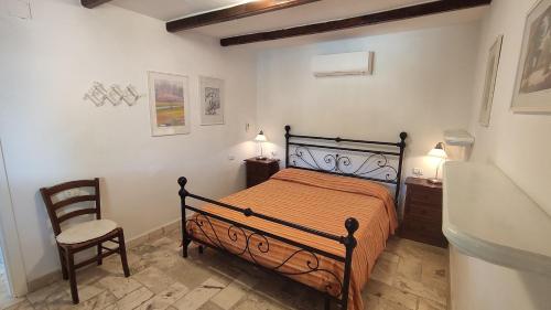 a bedroom with a bed and a chair in it at Appartamenti Pagni in Casa Morcone