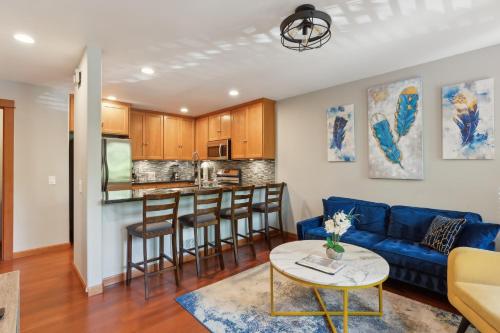 a living room with a blue couch and a table at Charming 2BR Townhouse near Green Lake in Seattle