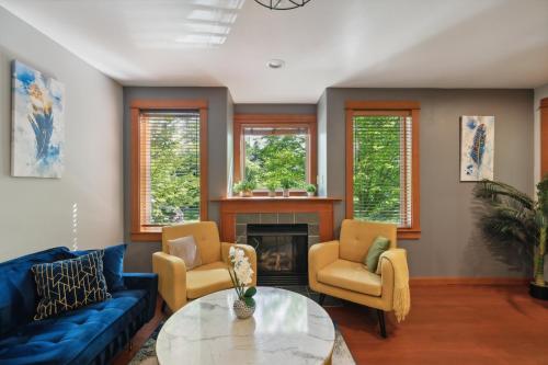 a living room with blue furniture and a fireplace at Charming 2BR Townhouse near Green Lake in Seattle
