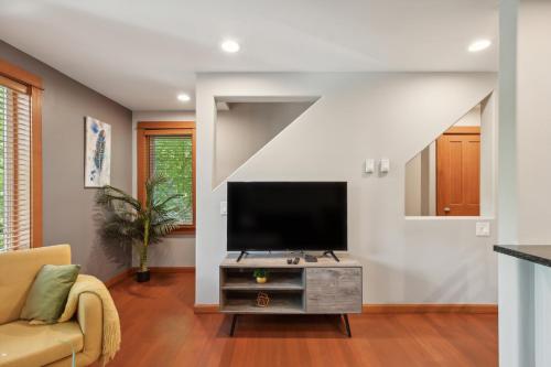 a living room with a flat screen tv on a table at Charming 2BR Townhouse near Green Lake in Seattle
