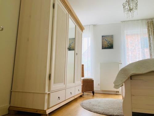 ein Schlafzimmer mit einem großen weißen Schrank mit einem Spiegel in der Unterkunft Casa Cinzia Sara in Eckernförde
