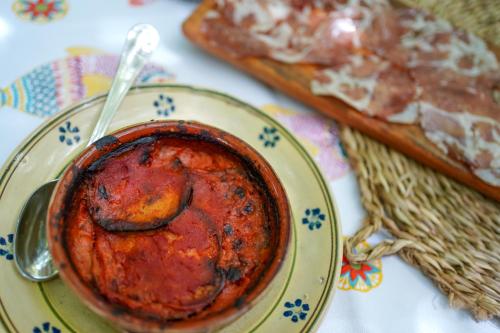 a bowl of sauce on a plate with a spoon at Villa Pesce in Selva di Fasano