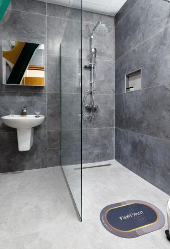 a bathroom with a shower and a sink at Hotel Green Center Gili in Gostivar