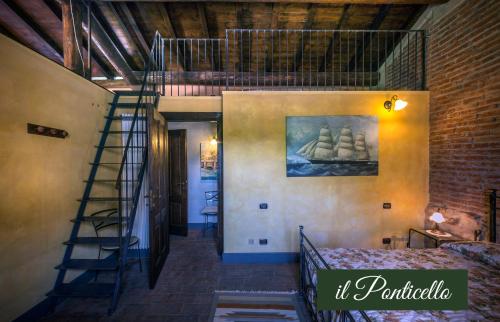 a room with a spiral staircase in a building at Il Borghetto Vacanze nei Mulini in Valeggio sul Mincio
