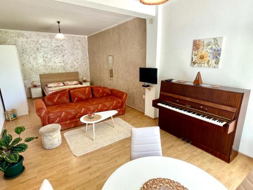 a living room with a couch and a piano at Apartments Marina in Budva