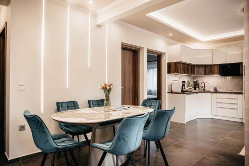 a kitchen and dining room with a table and chairs at Luxury Wellness Home II. Balatonboglár in Balatonboglár