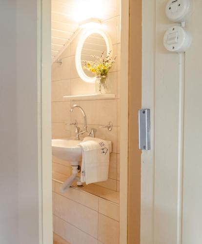 a bathroom with a sink and a mirror at Blue House Apartments in Vasilikos