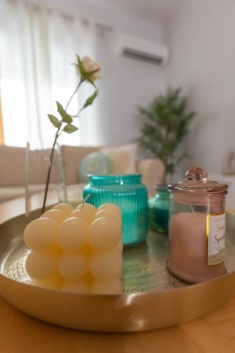 a plate with eggs and a candle on a table at Silver Palm House Ixia, Rhodes in Ixia