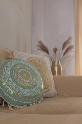 a blue and white pillow sitting on a couch at Silver Palm House Ixia, Rhodes in Ixia