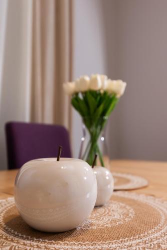a candle on a table with a vase with a flower at Silver Palm House Ixia, Rhodes in Ixia