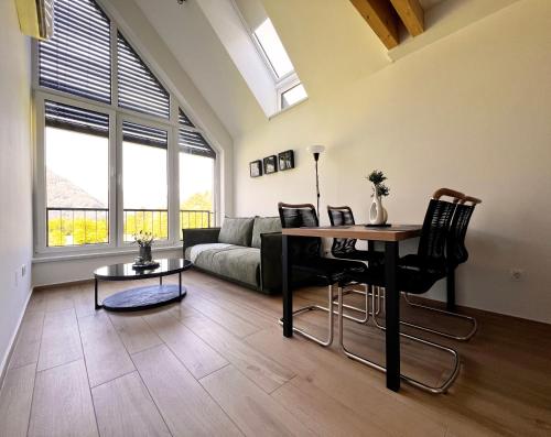 a living room with a table and a couch at Alpine Haven in Bovec