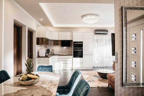 a kitchen and living room with a table and chairs at Luxury Wellness Home II. Balatonboglár in Balatonboglár