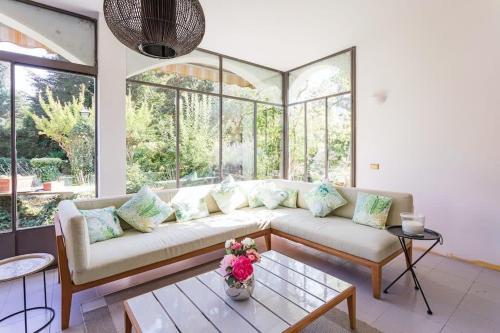 a living room with a couch and some windows at Lesa villa near the lakeside in Lesa