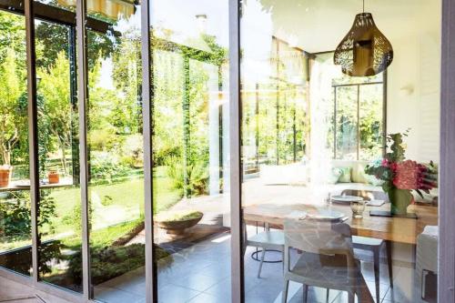 a dining room with a table and glass doors at Lesa villa near the lakeside in Lesa