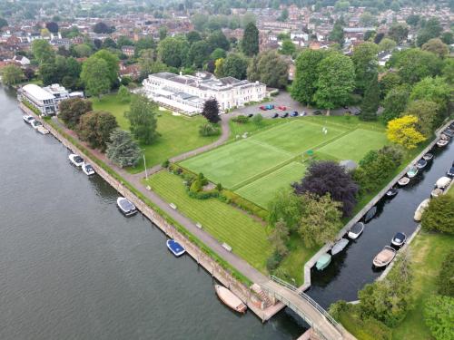 an aerial view of a park with boats in a river at Phyllis Court Members Club in Henley on Thames