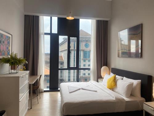 a hotel room with a bed and a large window at Eastern Suites Star KLcc in Kuala Lumpur