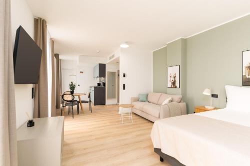 a bedroom with a bed and a living room at Limehome Vienna Favoritenstr in Vienna