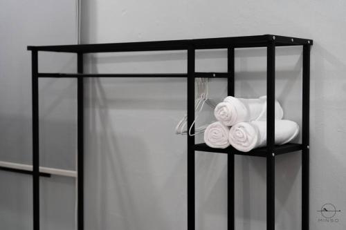 a black shelf with towels on it at [Party House Megah Ria] #65'Tv #1600sqf Open space in Masai