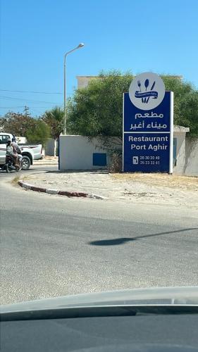 a sign for a restaurant on the side of a road at Dar Sana in Arkou