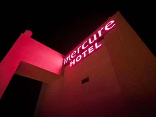 a neon sign on the side of a building at Mercure Sochi Centre Hotel in Sochi