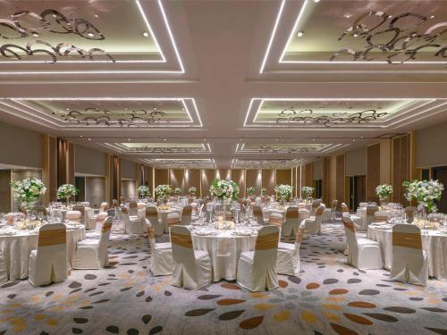 a banquet hall with tables and chairs in a room at Pullman Jakarta Indonesia in Jakarta