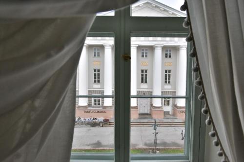 a view of the white house from a window at Antonius Hotel in Tartu