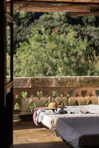 a bed sitting on top of a wall at Agroturismo Son Viscos in Valldemossa