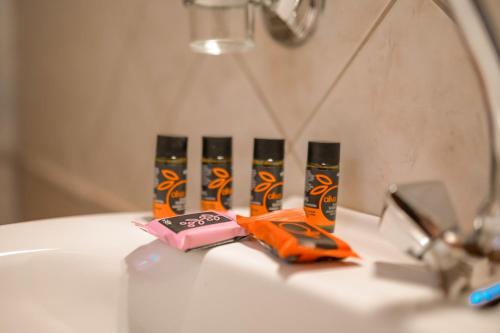 a group of four toothbrushes sitting on top of a sink at Agapi's Charming Retreat - Rustic Escape By Chania in Maláxa