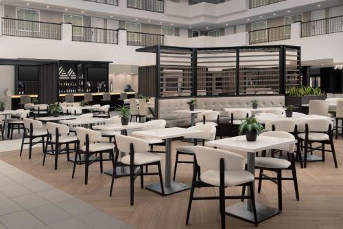 a restaurant with tables and chairs in a building at Embassy Suites La Quinta Hotel & Spa in La Quinta