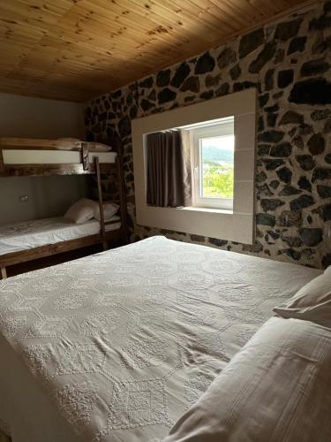 Un dormitorio con una cama grande y una ventana en 3 VELLEZERIT DOCI GUEST HOUSE, en Fushë-Lurë
