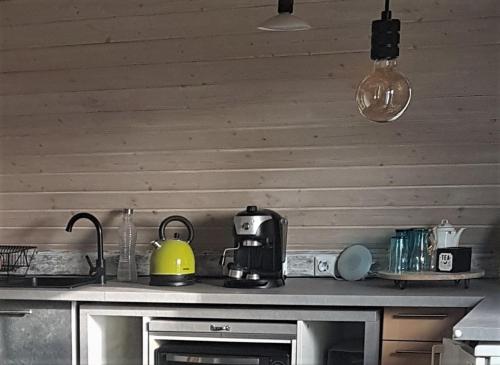 a kitchen counter with a yellow tea kettle on it at 1 Zimmer Appartement mit Bad in Königsbrunn
