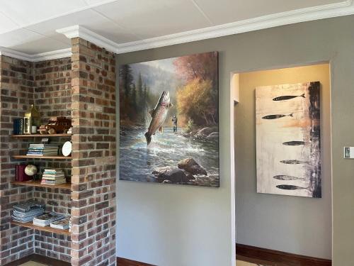 a painting of a dolphin hanging on a wall at Walkersons Trout and Nature Haven in Dullstroom