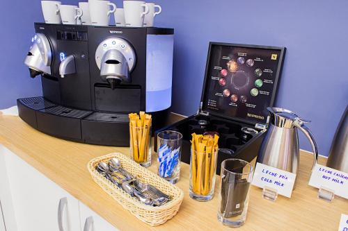 a coffee maker on a counter with glasses on it at Boutique Hostemplo Sagrada Familia in Barcelona