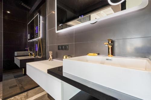 une salle de bain avec deux lavabos et un miroir dans l'établissement Sexy Dream Heliopolis, au Cap d'Agde