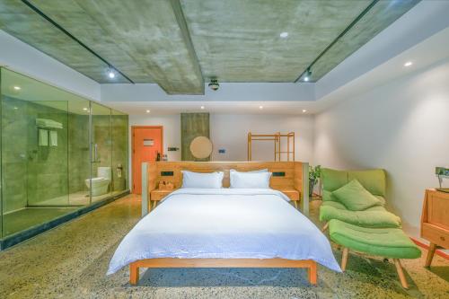 a bedroom with a bed and a glass shower at Heaven's Gate Lodge XMAN-Free pick up in Zhangjiajie
