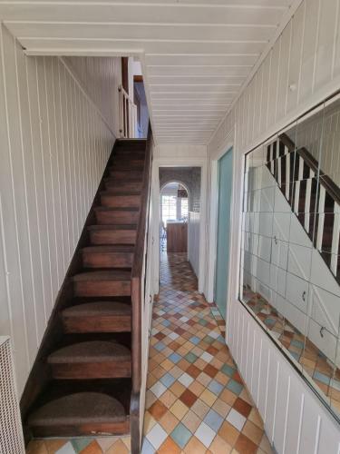 a staircase in a house with a tile floor at Lille Lykke2 - Direkt am Golfplatz & Nahe Grömitz & Strand in Schashagen