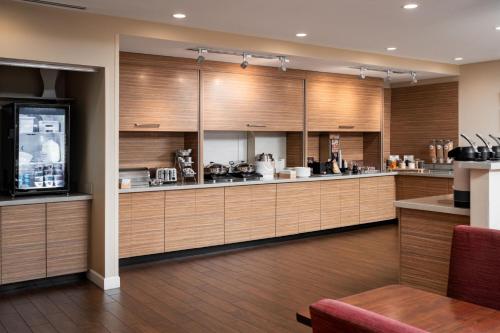 a large kitchen with wooden cabinets and appliances at TownePlace Suites by Marriott Cleveland in Cleveland