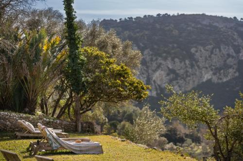 a group of lawn chairs sitting on top of a hill at Agroturismo Son Viscos in Valldemossa