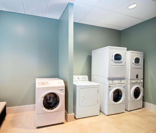 a laundry room with washing machines and a washer and dryer at Homewood Suites by Hilton Atlanta Buckhead Pharr Road in Atlanta