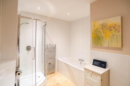 a bathroom with a shower and a toilet and a sink at 2-bedroom Apartment - Fistral Beach in Newquay