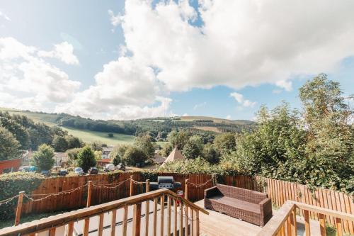 a view of the countryside from the deck of a house at Herons Lake Retreat Lodges in Caerwys