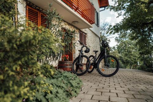 two bikes parked on the side of a building at Cozy family place 'Hiša Grozdek' - Gruškovec 40A in Gruškovec