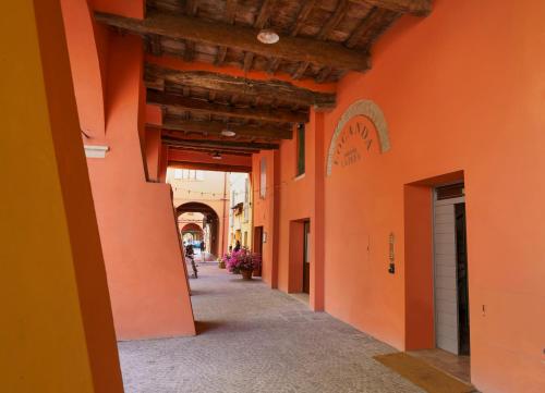 an alleyway in a building with orange walls at Locanda Osteria La Fefa in Finale Emilia