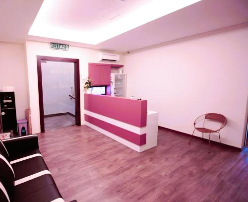 an empty room with a counter and a chair at BMW Hotel in Muar