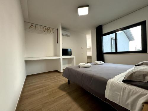 Ένα ή περισσότερα κρεβάτια σε δωμάτιο στο L'Ancora Luxury Apartments