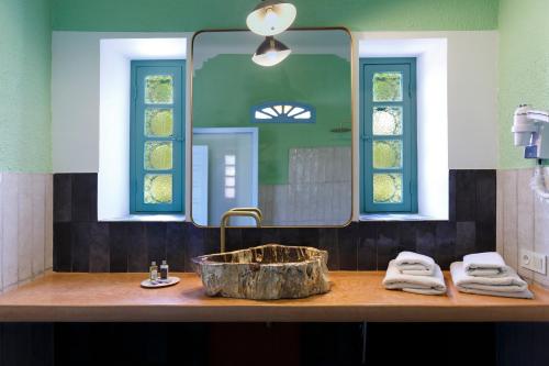 a bathroom with a sink and a large mirror at Riad Tamayourt Ocean View & piscine chauffée à 30 in Essaouira